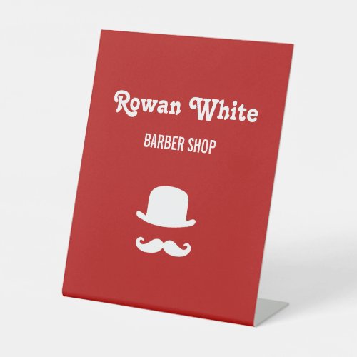 White hat and moustache silhouette red pedestal sign