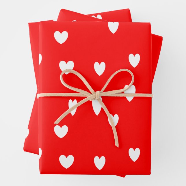 White hearts pattern on red wrapping paper sheets (In situ)
