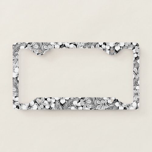 White hibiscus and palm leaves license plate frame