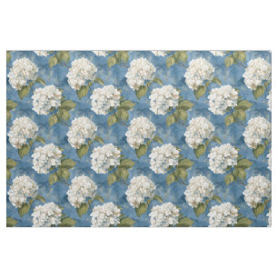 White hydrangea blossoms on blue  fabric