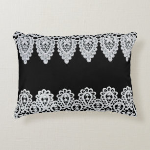 White lace forms a delicate border against black accent pillow
