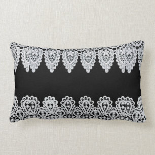 White lace forms a delicate border against black lumbar pillow