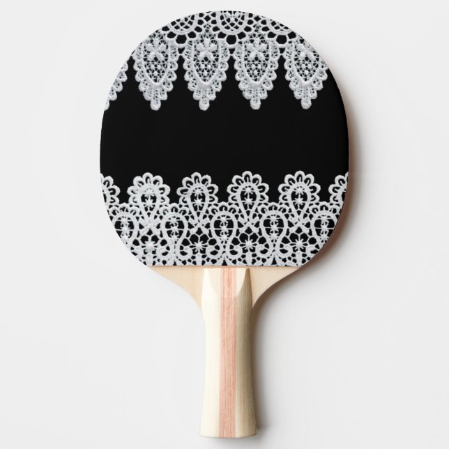 White lace forms a delicate border against black Ping-Pong paddle (Front)