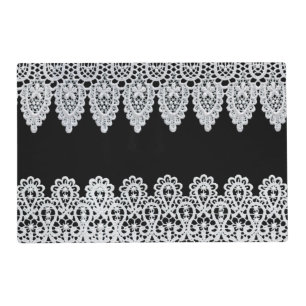 White lace forms a delicate border against black placemat