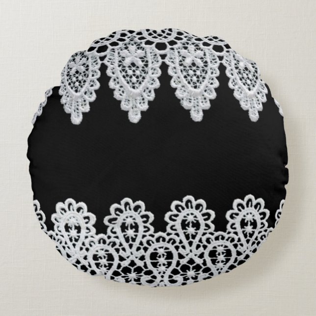 White lace forms a delicate border against black round pillow (Front)