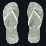 White Lace on Sage Green The Bride Elegant Wedding Flip Flops<br><div class="desc">Dance the night away with these beautiful wedding flip flops. Designed for the bride, they feature a simple yet elegant design with fancy script lettering on a sage green background and white lace curls and swirls. Beautiful way to stay fancy and appropriate while giving your feet a break after a...</div>