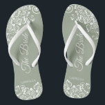 White Lace on Sage Green The Bride Elegant Wedding Flip Flops<br><div class="desc">Dance the night away with these beautiful wedding flip flops. Designed for the bride, they feature a simple yet elegant design with fancy script lettering on a sage green background and white lace curls and swirls. Beautiful way to stay fancy and appropriate while giving your feet a break after a...</div>