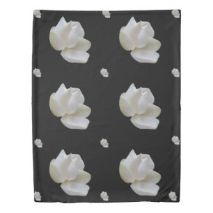 White Magnolia flower on dramatic black on a Duvet Cover