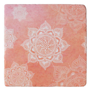 White mandalas on coral marble background trivet