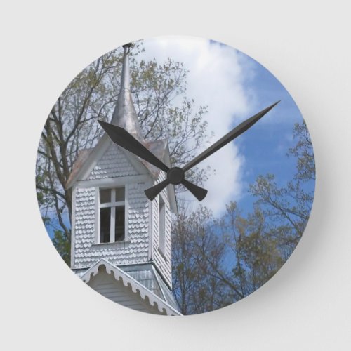 white old church in the mountains round clock