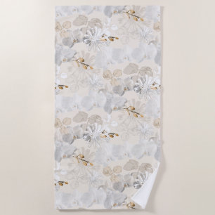 White orchids on a light cream beach towel