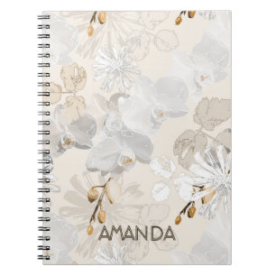 White orchids on a light cream notebook