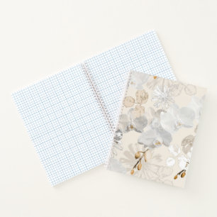 White orchids on a light cream notebook