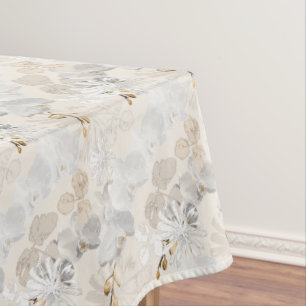 White orchids on a light cream tablecloth