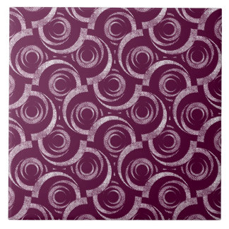 White ornament on a burgundy background. ceramic tile