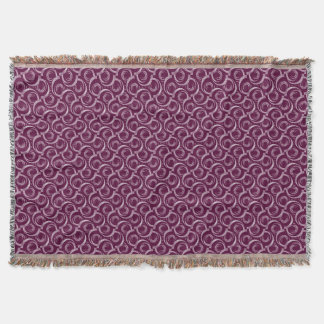 White ornament on a burgundy background. throw blanket