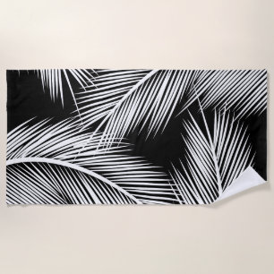 White palm leaves on black color background beach towel