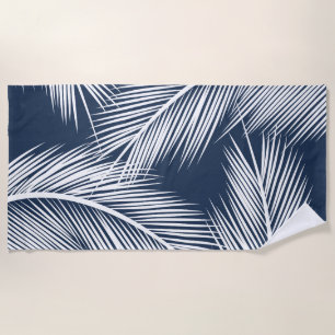White palm leaves on dark blue color background beach towel