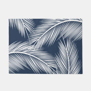 White palm leaves on dark blue color background doormat