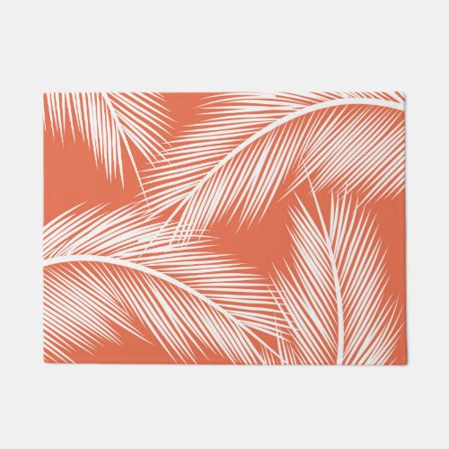 White palm leaves on salmon color background doormat