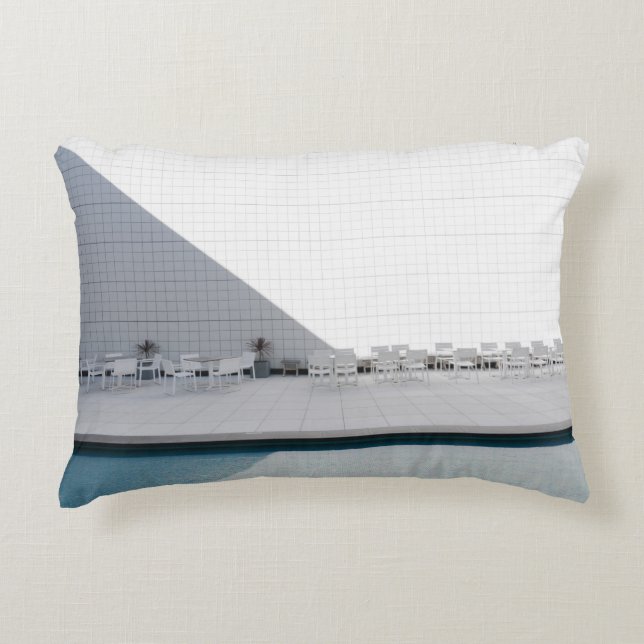 WHITE PATIO TABLE WITH CHAIRS DURING DAYTIME ACCENT PILLOW (Front)