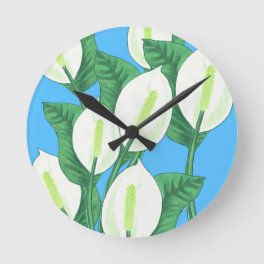 White peace lilies on pale blue background round clock
