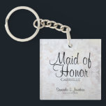 White Peonies Maid of Honor Wedding Favor Keychain<br><div class="desc">This beautiful keychain is perfect for thanking your Maid of Honor. Designed as a part of our White Reflections Wedding Suite, it features black text over a background of reflecting white flowers and hearts. The text is fully customizable and reads: Maid of Honor, with a place for her name, the...</div>