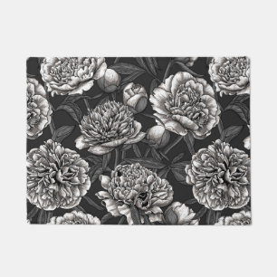 White peony flowers on dark gray doormat