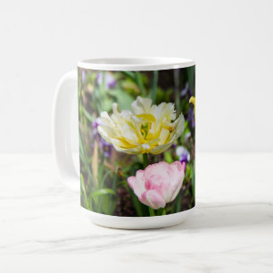 White, pink and yellow tulips in the garden     coffee mug