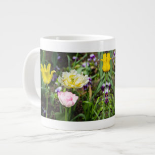 White, pink and yellow tulips in the garden giant coffee mug