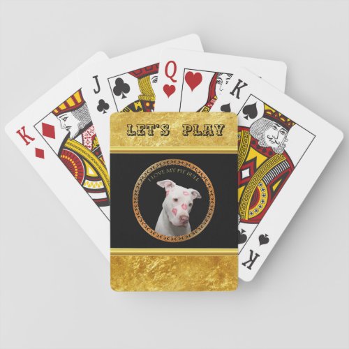 White pitbull with red kisses all over his face playing cards