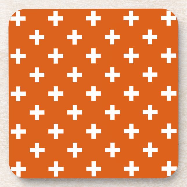 White polka crosses on burnt orange beverage coaster (Front)
