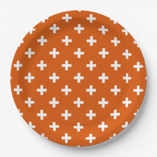White polka crosses on burnt orange paper plates
