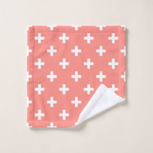 White polka crosses on peach wash cloth