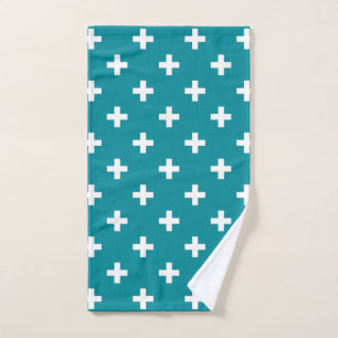 White polka crosses on teal hand towel