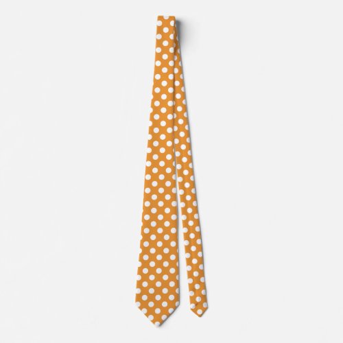 White polka dots on amber tie