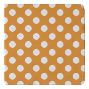 White polka dots on amber trivet
