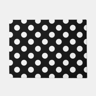 White polka dots on black doormat