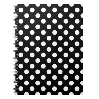 White polka dots on black notebook