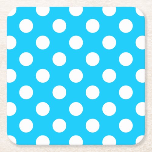 White polka dots on electric blue square paper coaster