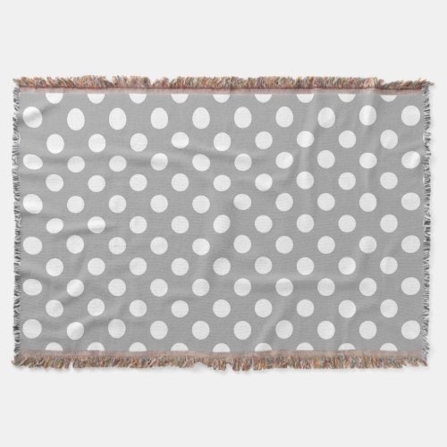 White polka dots on grey throw blanket