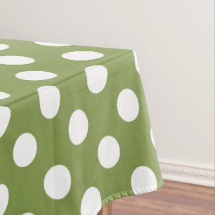 White polka dots on olive green tablecloth