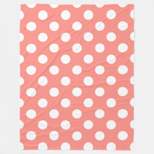 White polka dots on peach fleece blanket