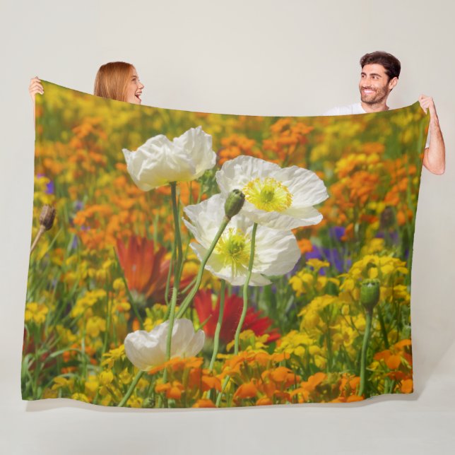 White poppies growing around the colorful flowers fleece blanket (In Situ)