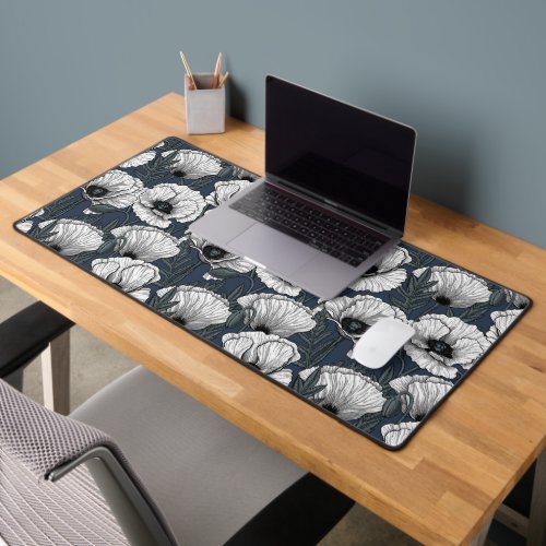 White poppies on navy desk mat