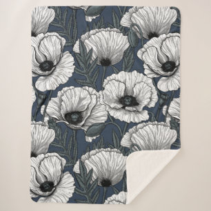 White poppies on navy sherpa blanket