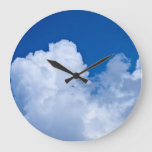 White puffy clouds in blue sky large clock