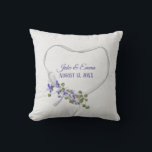 White Ribbon Heart with Wedding Date Throw Pillow<br><div class="desc">Purple flowers with green ivy bouquet on white satin ribbon heart on off white speckled background.
Names and wedding date are editable.
Can be used for anniversary or wedding gift.</div>