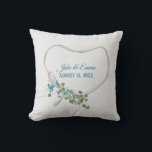 White Ribbon Heart with Wedding Date Throw Pillow<br><div class="desc">Aqua blue flowers with green ivy bouquet on white satin ribbon heart on off white speckled background.
Names and wedding date are editable.
Can be used for anniversary or wedding gift.</div>