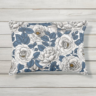 White roses with blue leaves on white outdoor pillow
